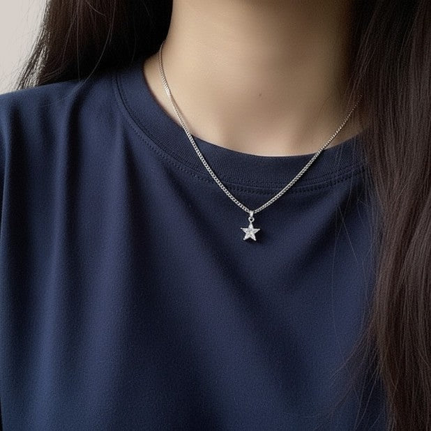 Amara Jewels silver 925 sterling silver necklace with a small, clear star pendant and a curb chain.