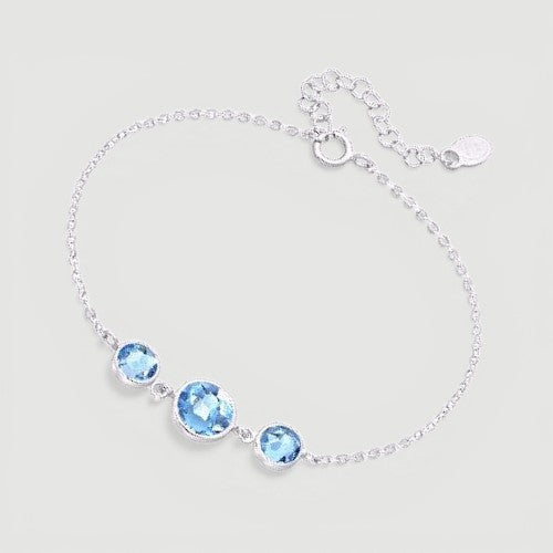 Amara Jewels delicate 925 sterling silver bracelet with three round sky blue topaz stones and adjustable chain.