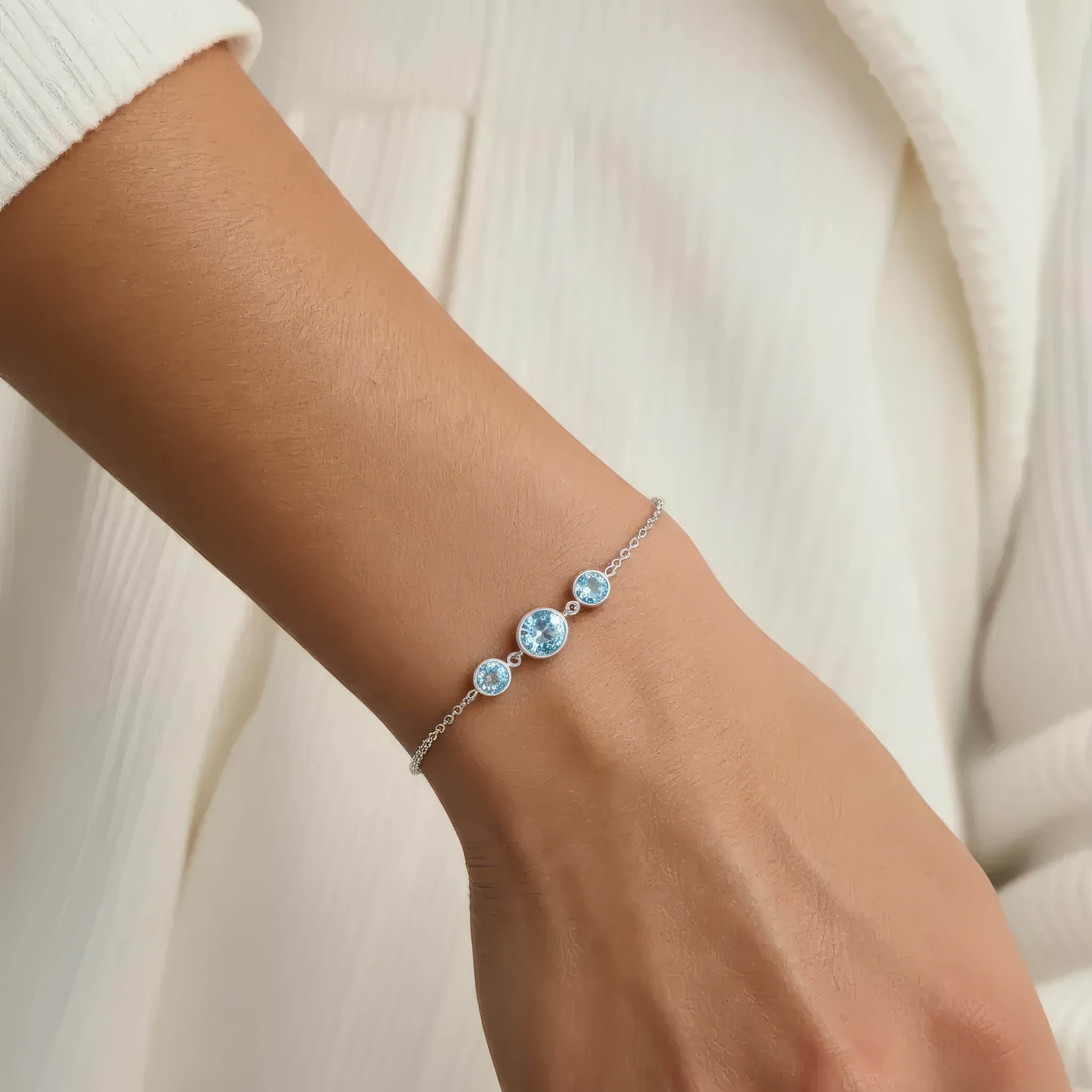 Amara Jewels delicate 925 sterling silver bracelet with three round sky blue topaz stones and adjustable chain.