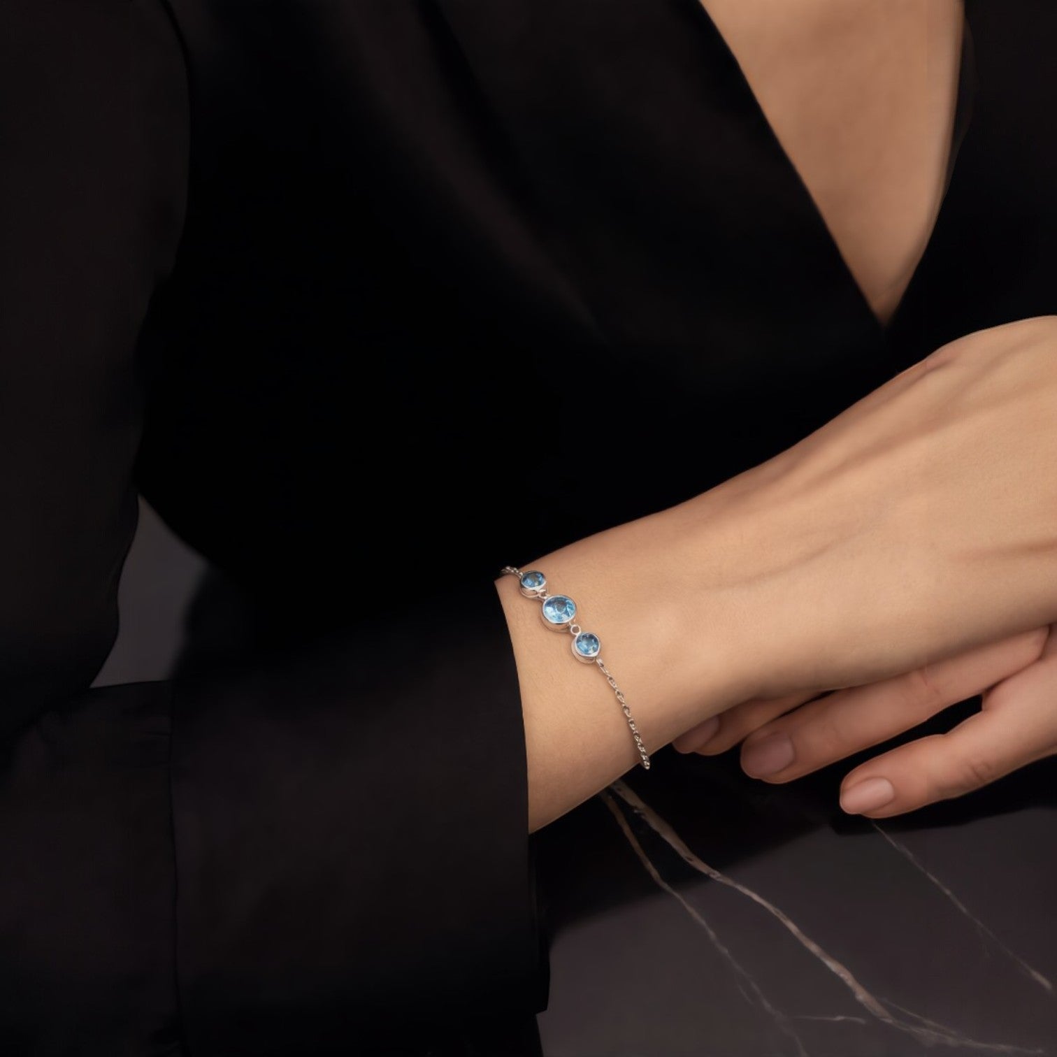 Amara Jewels delicate 925 sterling silver bracelet with three round sky blue topaz stones and adjustable chain.