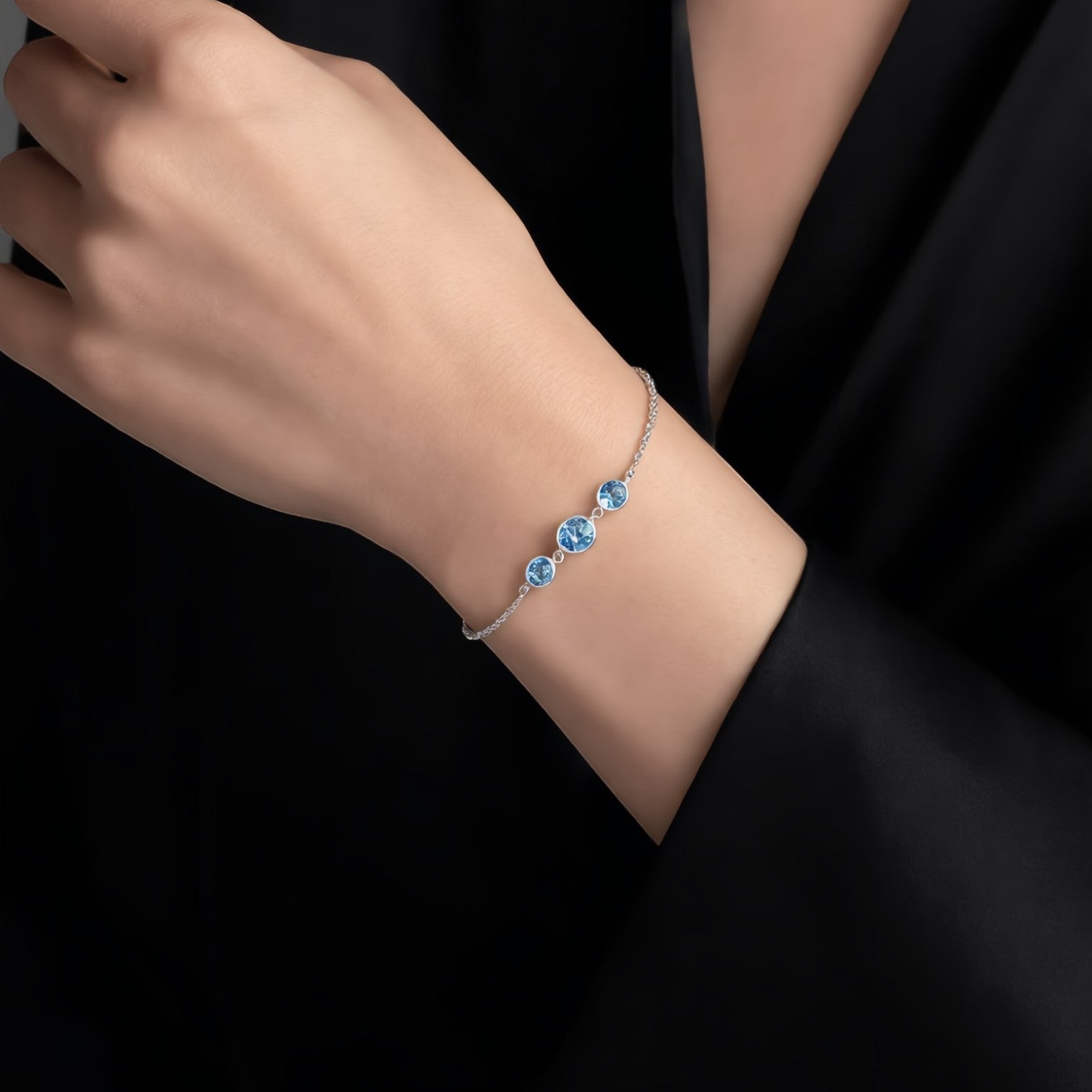 Amara Jewels delicate 925 sterling silver bracelet with three round sky blue topaz stones and adjustable chain.