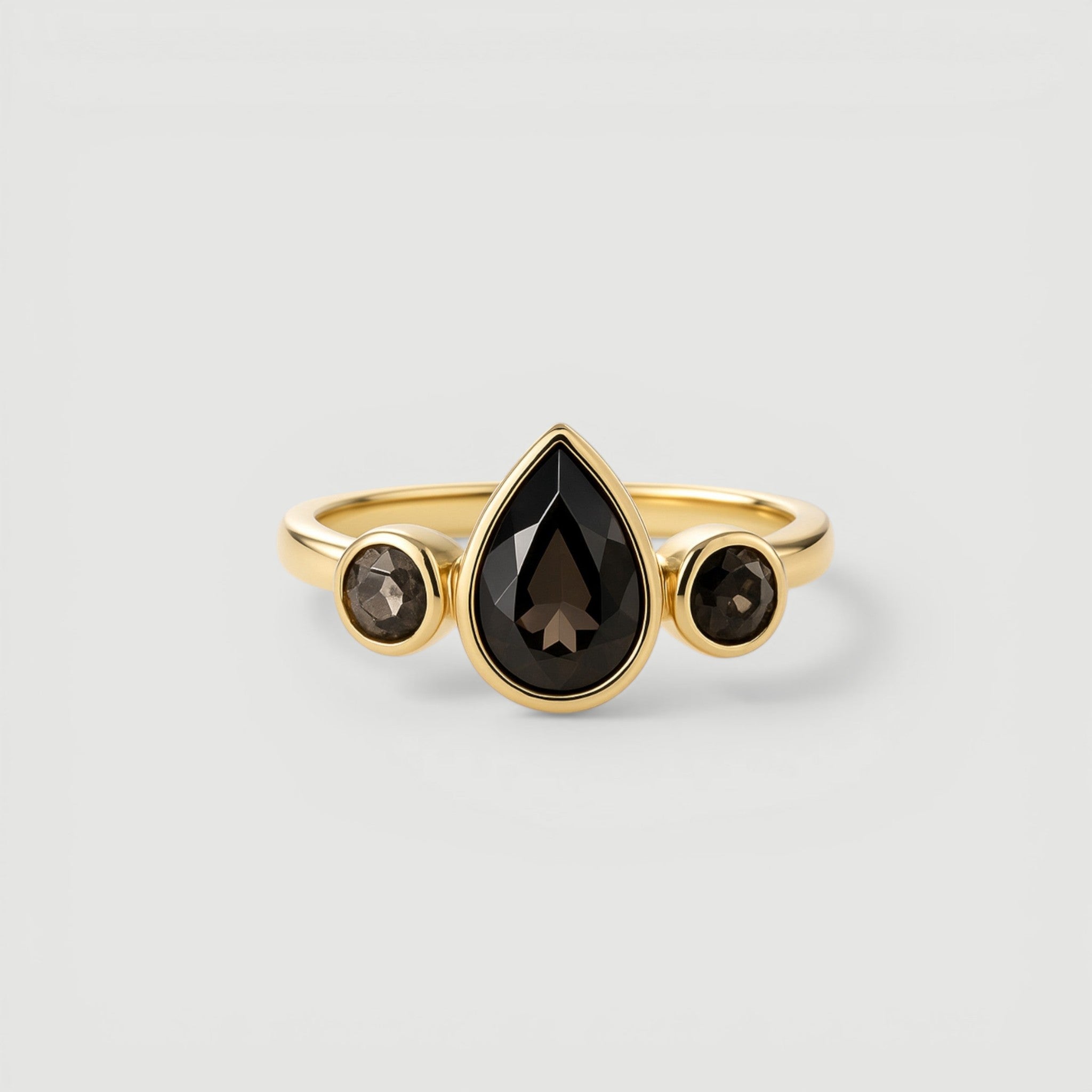 Amara Jewels gold vermeil ring with pear-cut and round-cut smoky topaz gemstones.