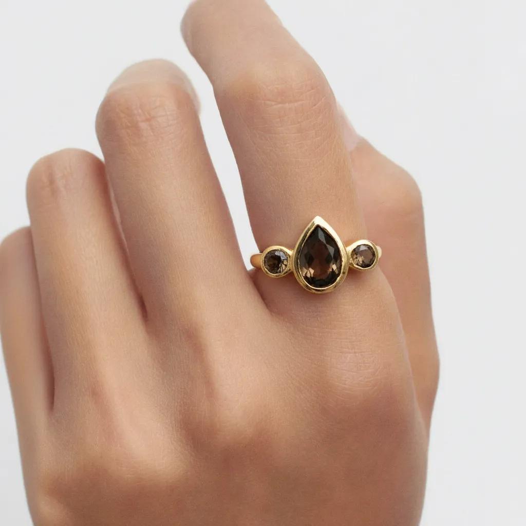 Amara Jewels gold vermeil ring with pear-cut and round-cut smoky topaz gemstones.
