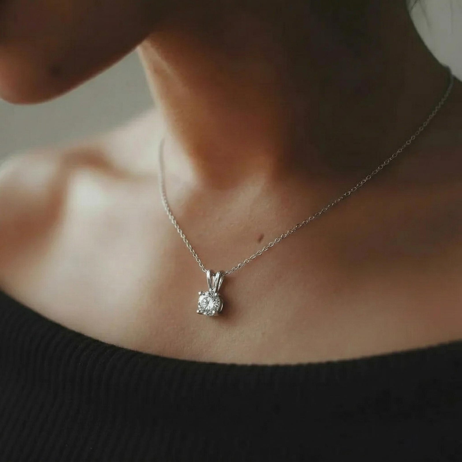 Amara Jewels 925 sterling silver solitaire pendant necklace with four-prong setting and a clear, round-cut gemstone.
