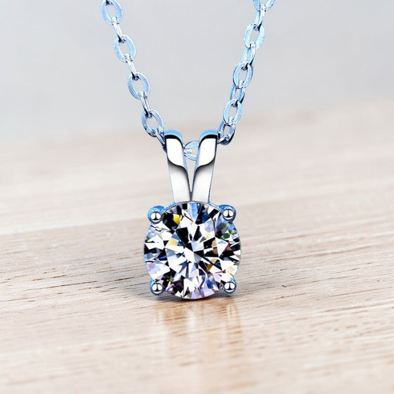 Amara Jewels 925 sterling silver solitaire pendant necklace with four-prong setting and a clear, round-cut gemstone.