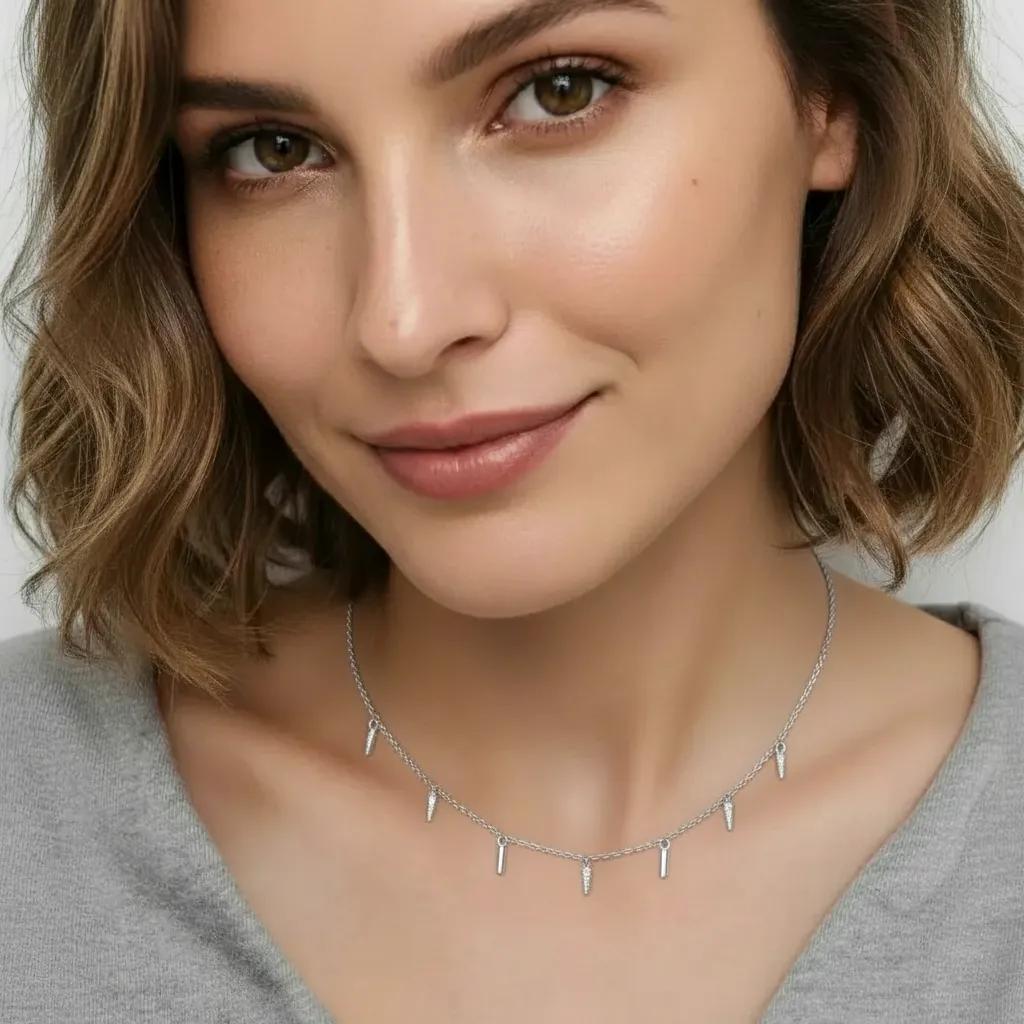 Amara Jewels rhodium-plated sterling silver necklace with dangling spike charms and clear crystals.