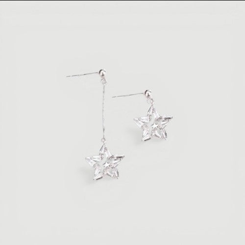 Amara Jewels mismatched star drop earrings with cubic zirconia in sterling silver with gold plating.