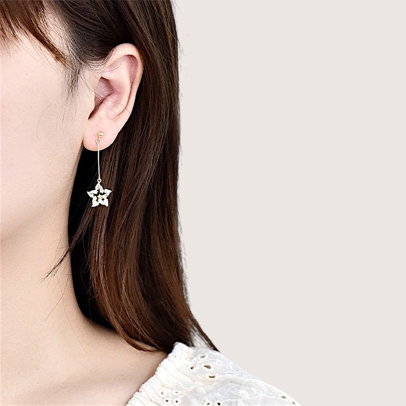 Amara Jewels mismatched star drop earrings with cubic zirconia in sterling silver with gold plating.