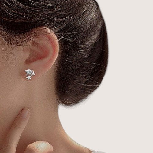 Amara Jewels rhodium-plated sterling silver stud earrings with a cluster of three stars, one paved with small crystals.