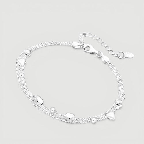 Amara Jewels delicate dual-layered sterling silver bracelet with heart charms and small beads.
