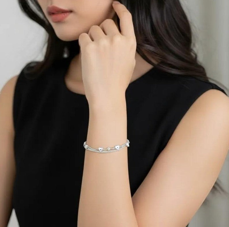 Amara Jewels delicate dual-layered sterling silver bracelet with heart charms and small beads.