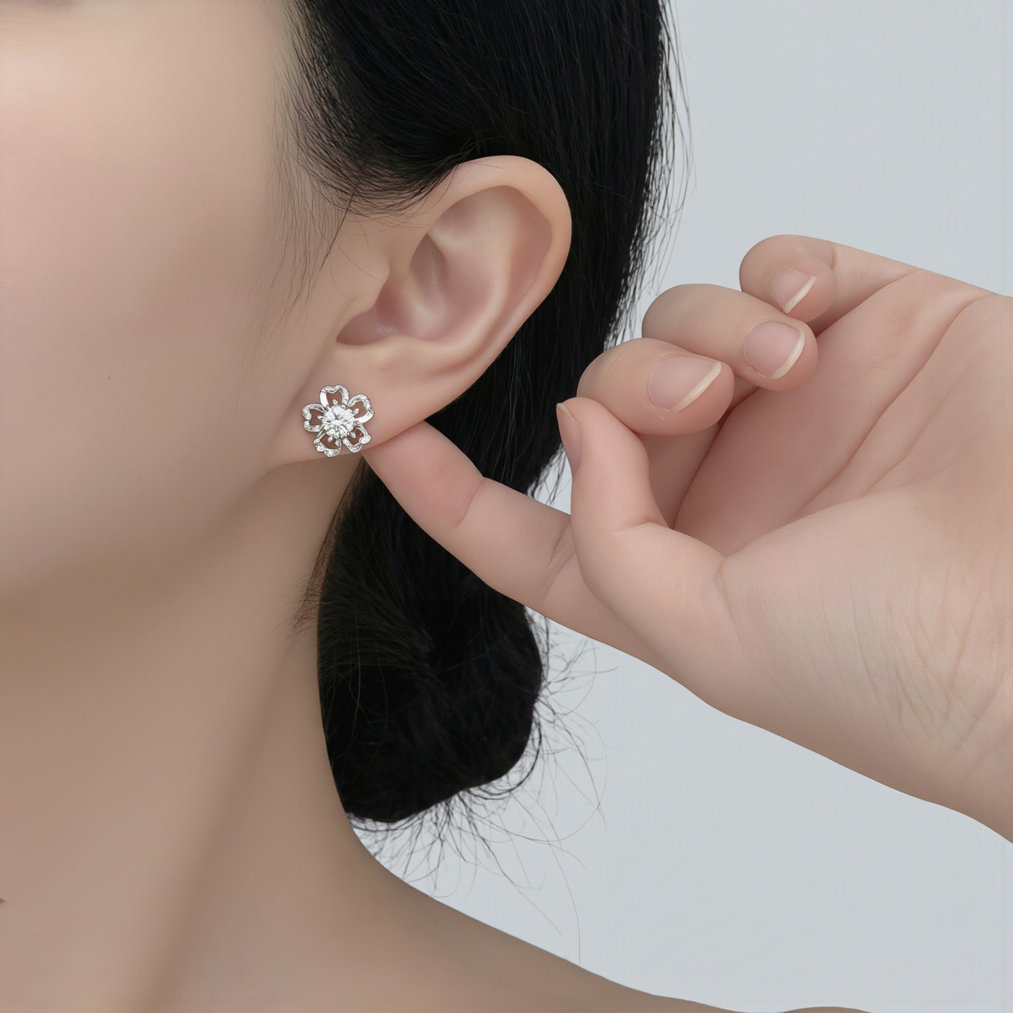 Amara Jewels sterling silver flower petal stud earrings with a central round stone, symbolizing love and elegance.