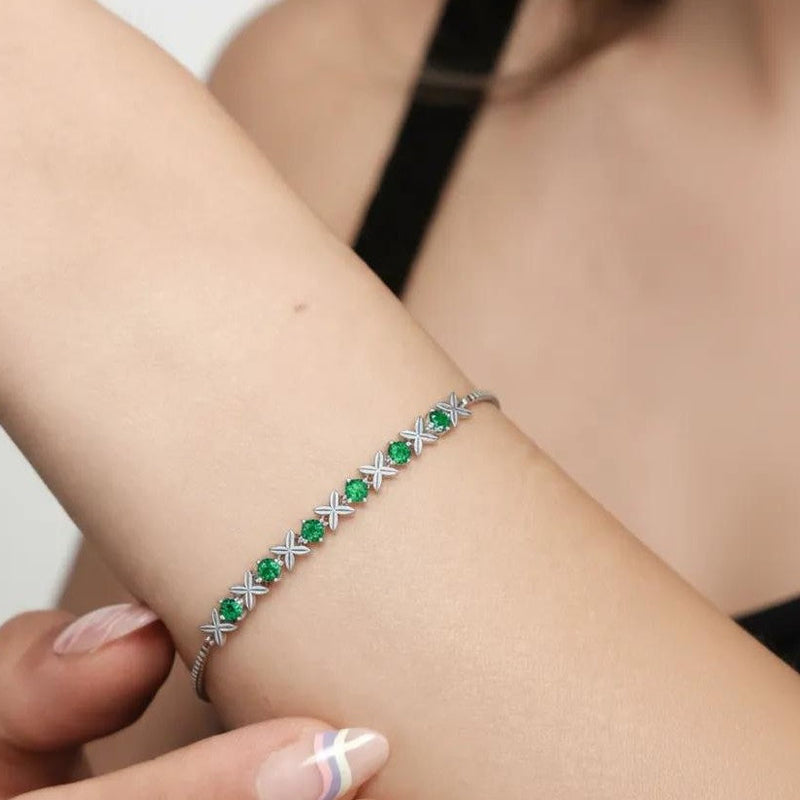 Amara Jewels sterling silver bracelet with green gemstones set in a flower design. Adjustable slider clasp.