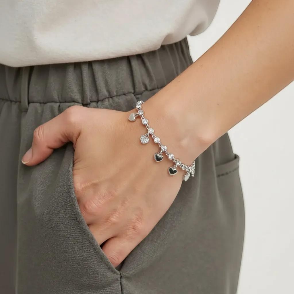 Amara Jewels sterling silver bracelet with cubic zirconia stones and dangling heart charms.