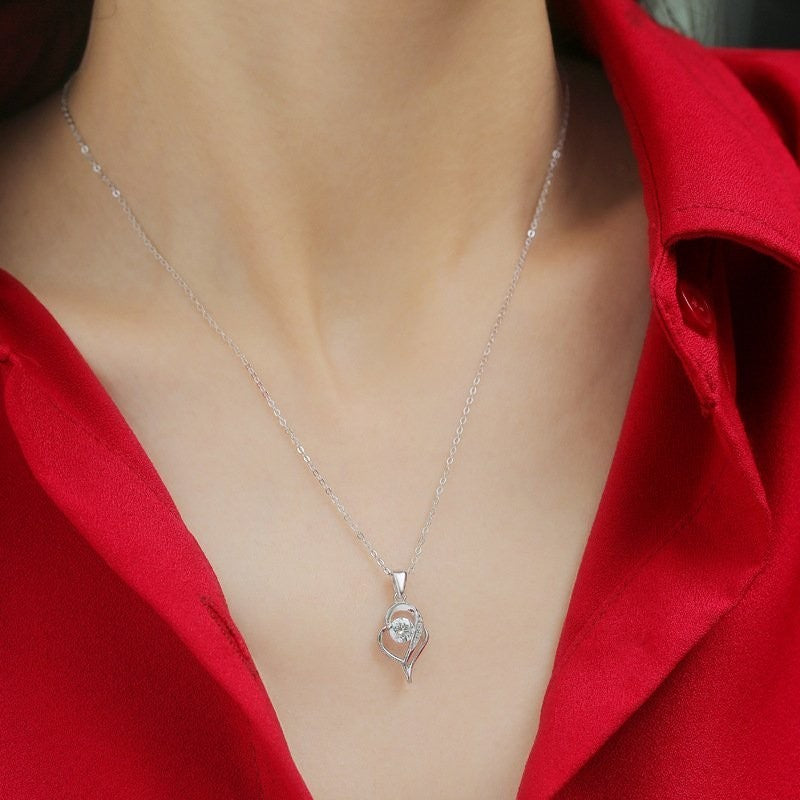 Amara Jewels sterling silver necklace with an irregular heart pendant featuring a cubic zirconia and accent stones.