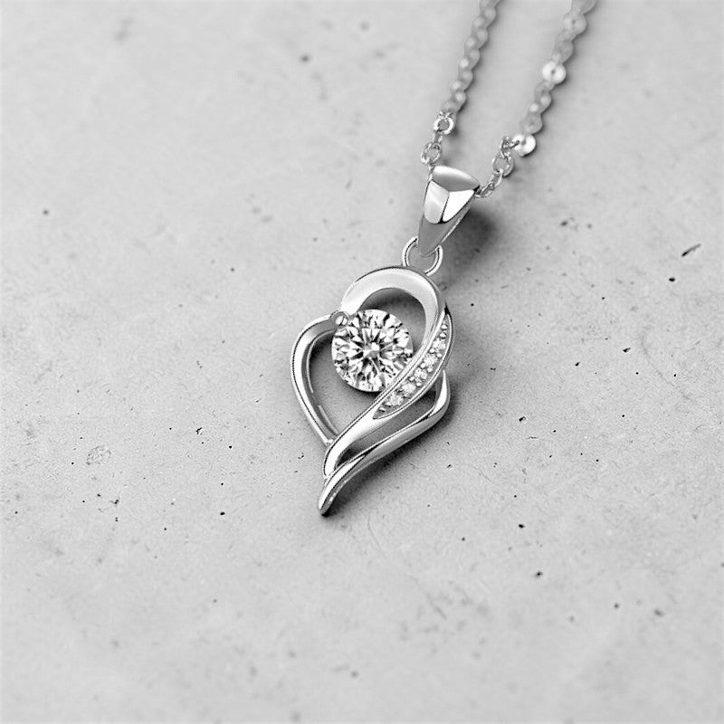 Amara Jewels sterling silver necklace with an irregular heart pendant featuring a cubic zirconia and accent stones.