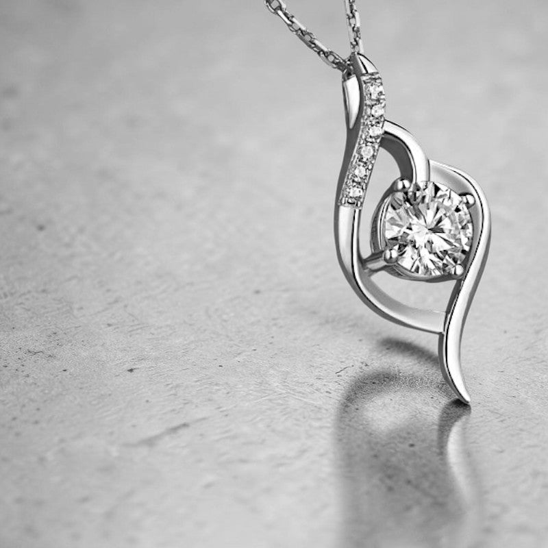 Amara Jewels Sterling Silver Infinity Twirl Pendant Necklace with round-cut crystal and small accent stones.