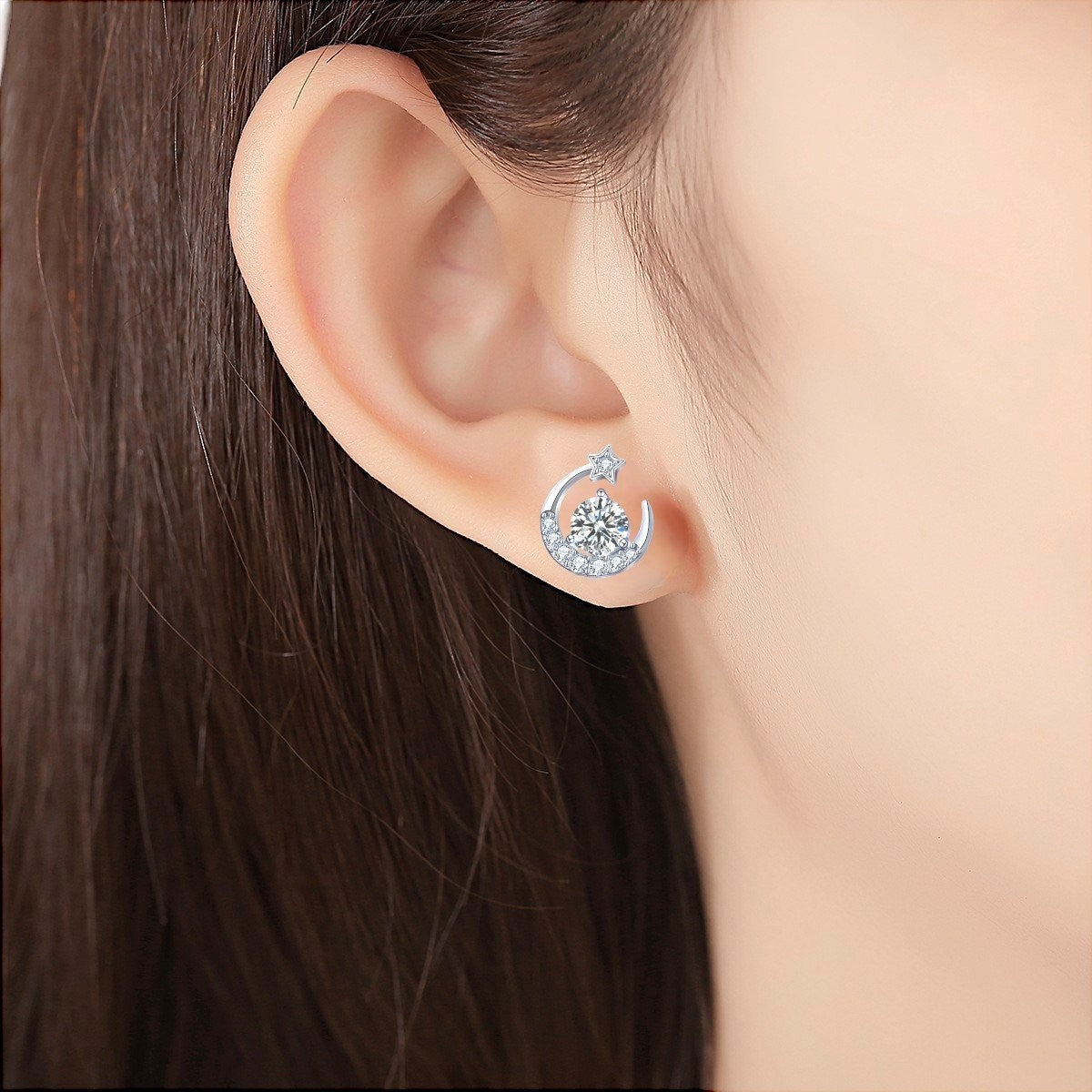 Amara Jewels Sterling Silver crescent moon stud earrings with star and clear crystals. Celestial design.
