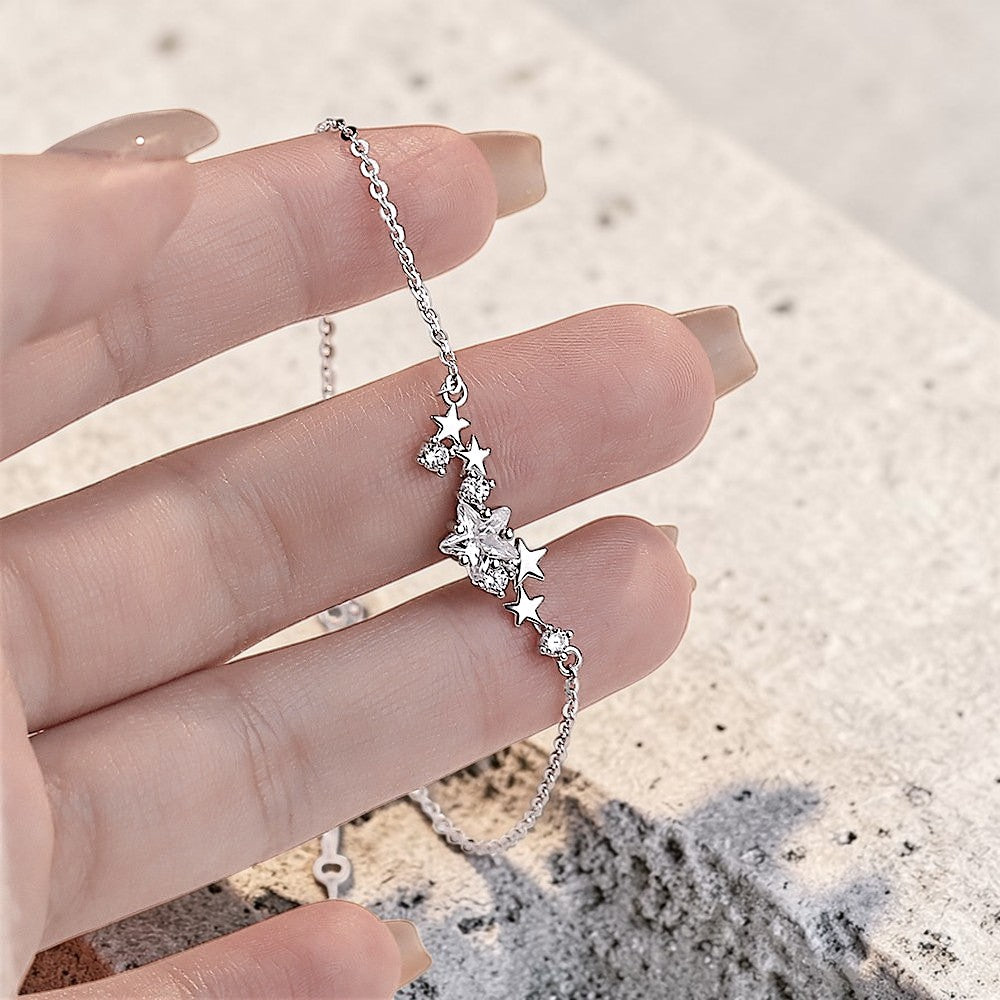 Amara Jewels sterling silver bracelet with a cluster of five sparkling cubic zirconia stars and an adjustable chain.