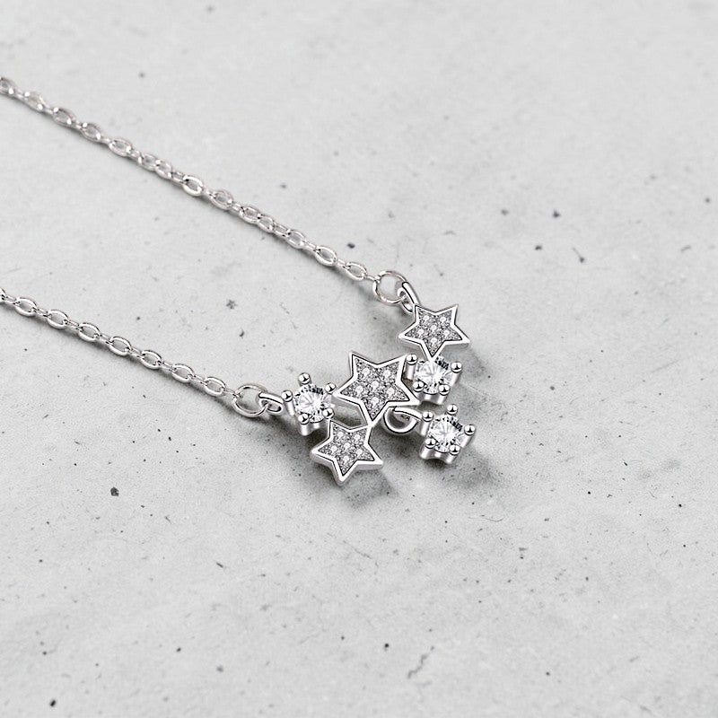 Amara Jewels sterling silver necklace with a cluster of sparkling star pendants adorned with crystals.