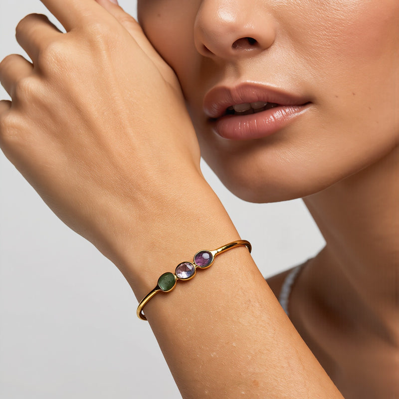 Amara Jewels 18K gold vermeil wrap bracelet with three bezel-set oval tourmaline gemstones in pink, green, and red.