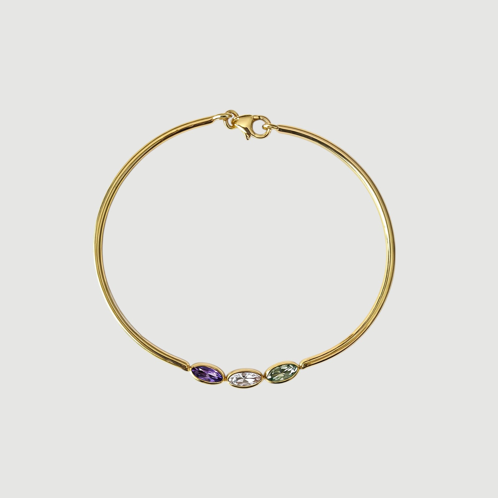 Amara Jewels 18K gold vermeil wrap bracelet with three bezel-set oval tourmaline gemstones in pink, green, and red.