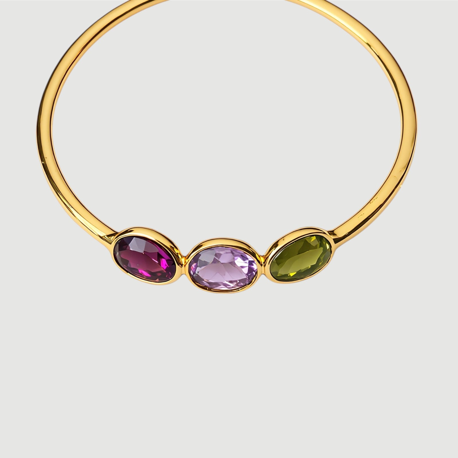 Amara Jewels 18K gold vermeil wrap bracelet with three bezel-set oval tourmaline gemstones in pink, green, and red.