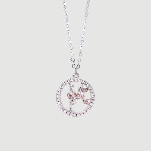 Amara Jewels rhodium-plated sterling silver Tree of Life pendant necklace with pink stones and clear crystals.