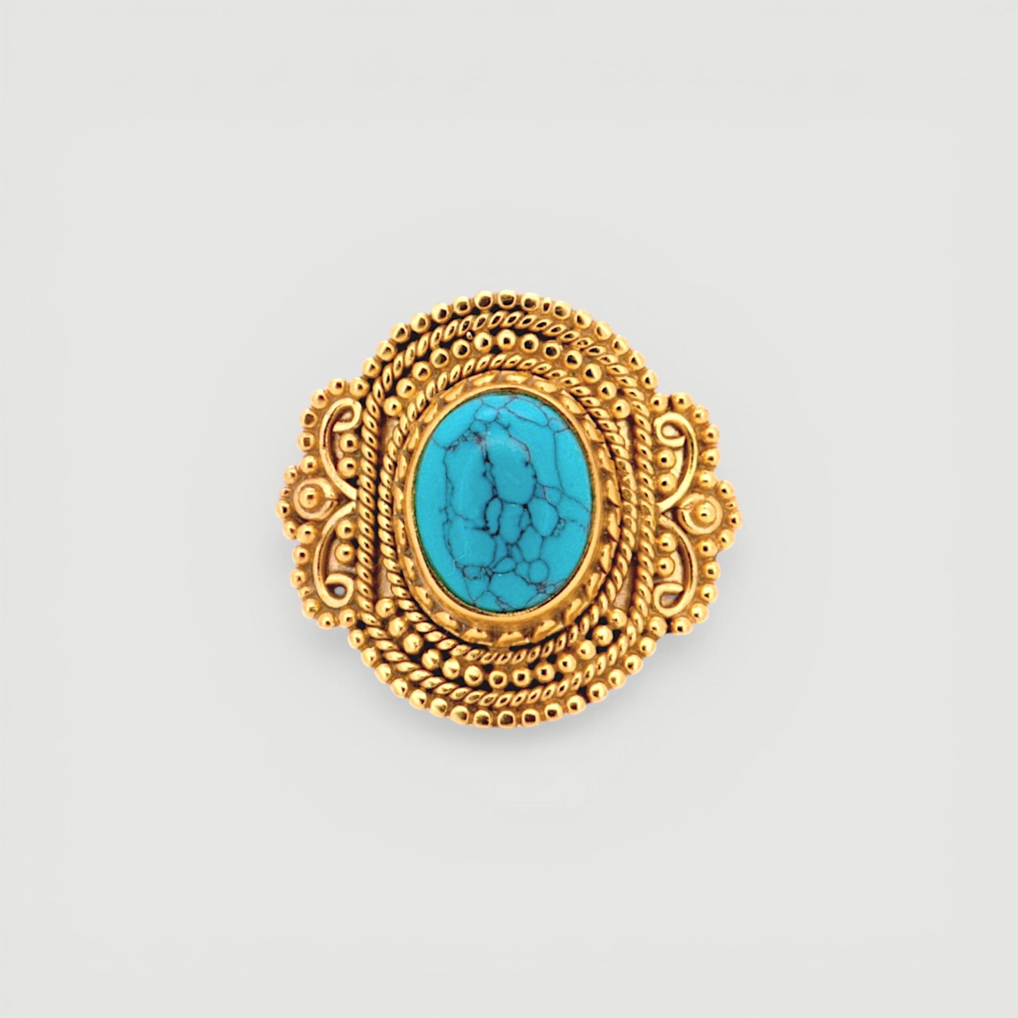 Amara Jewels antique-inspired oval turquoise ring with intricate gold detailing on sterling silver with 18K gold plating.