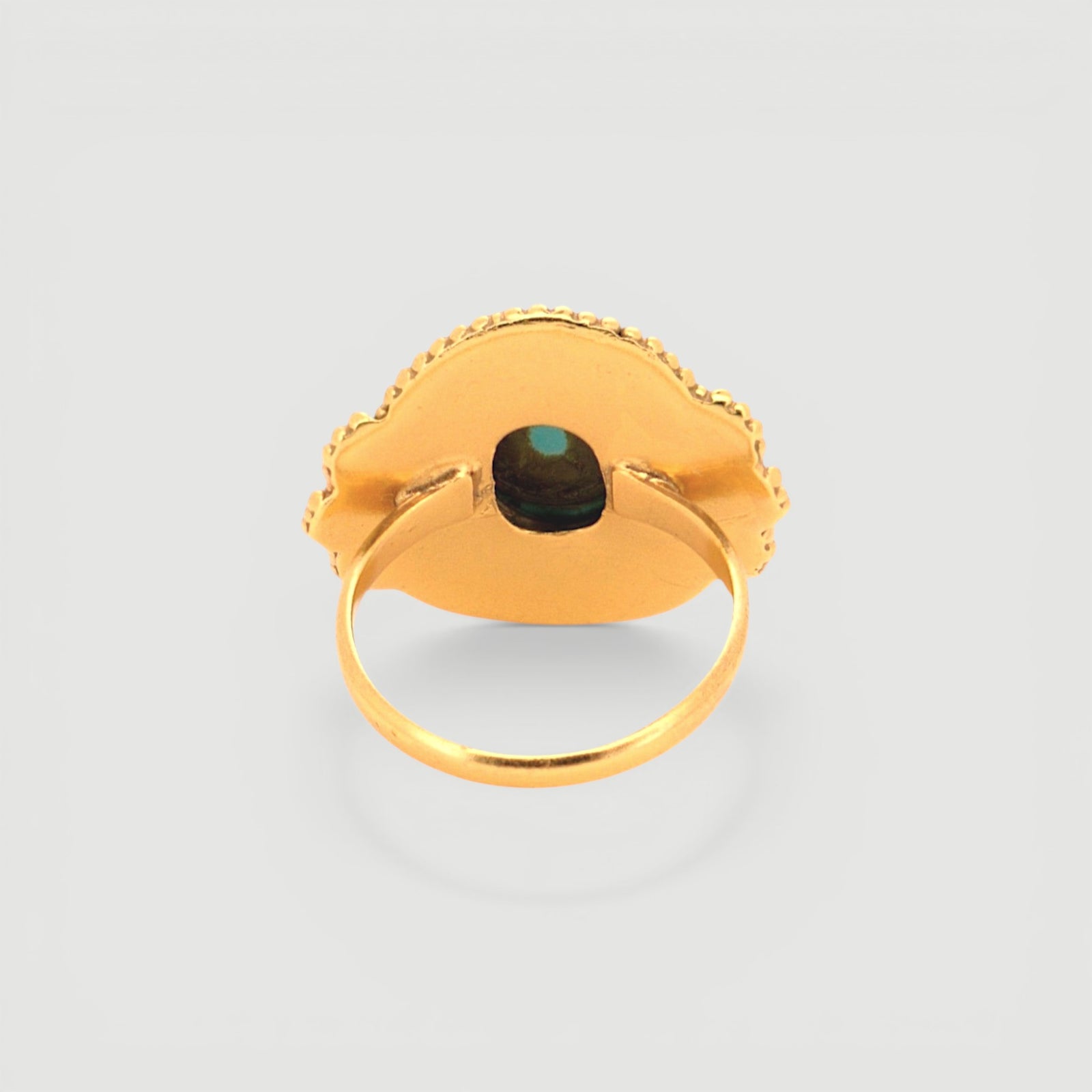 Amara Jewels antique-inspired oval turquoise ring with intricate gold detailing on sterling silver with 18K gold plating.