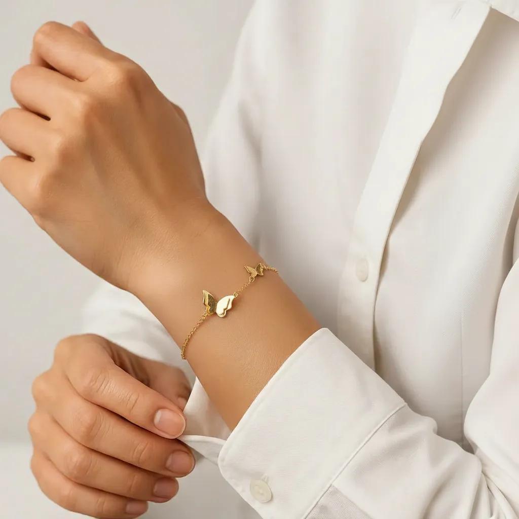 Amara Jewels delicate gold-plated 925 sterling silver bracelet with two butterfly charms and an adjustable chain.